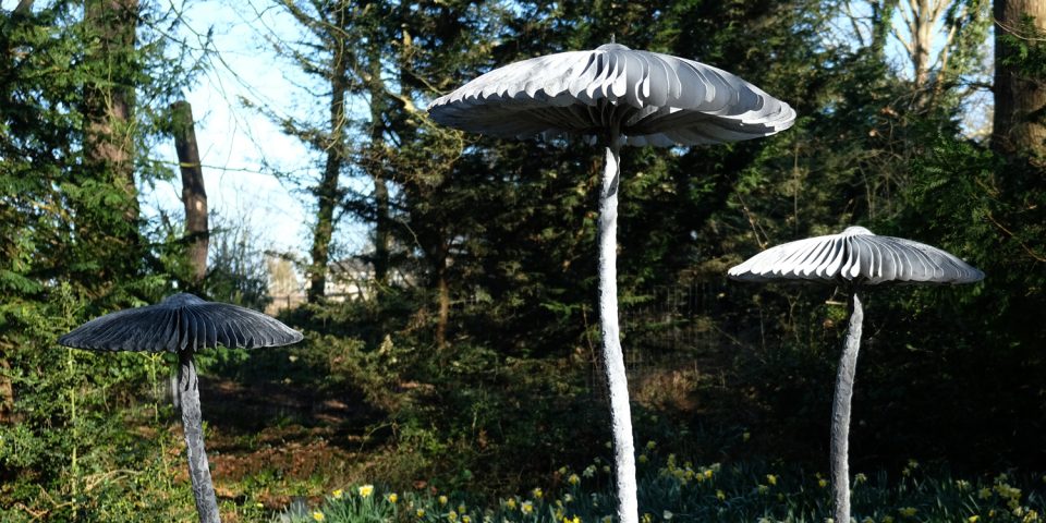 Close up detail of the mushroom caps made up of radiating metal parts and finished in chalky grey oxidised zinc.