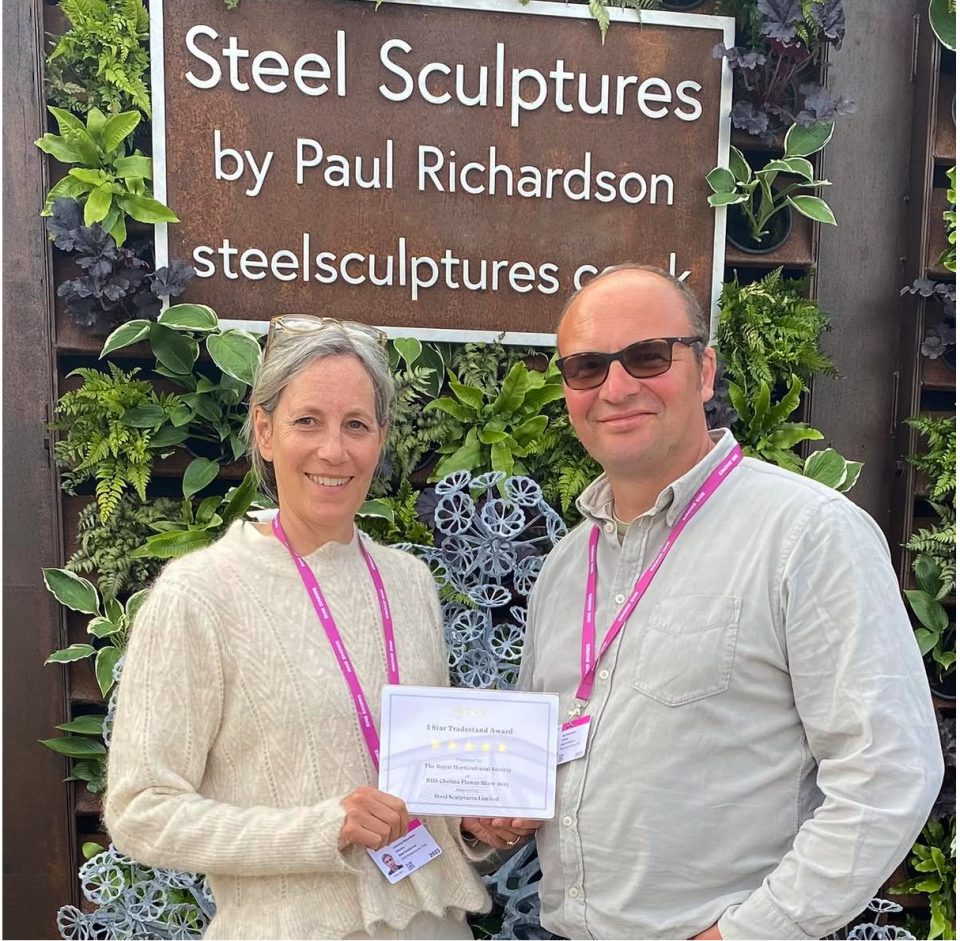 Catherine and Paul Richardson receiveing a five star trade stand award at RHS Chelsea Flower Show in 2022