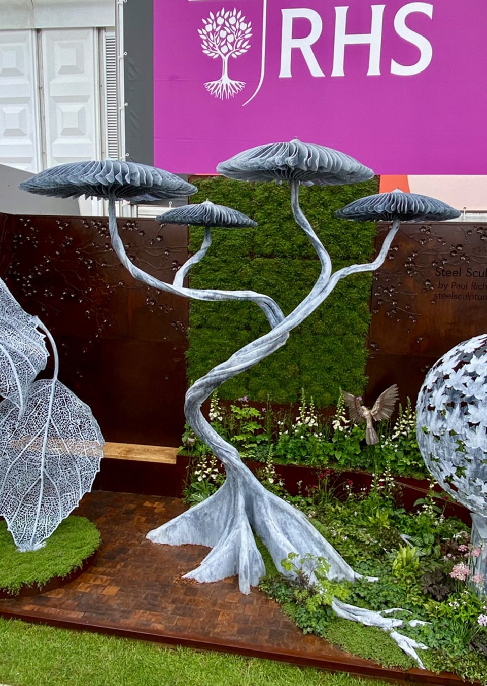 Four Mushroom Tree as a centre piece in a shallow space with planting and path on our trade stand, Chelsea Flower show 2025.
