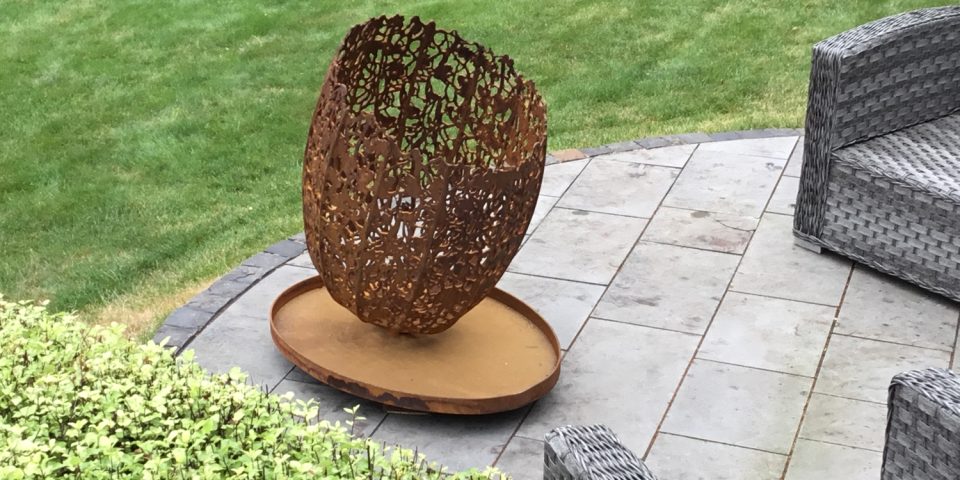 Small Filigree Fire Basket on a curved outdoor terrace seen from above.